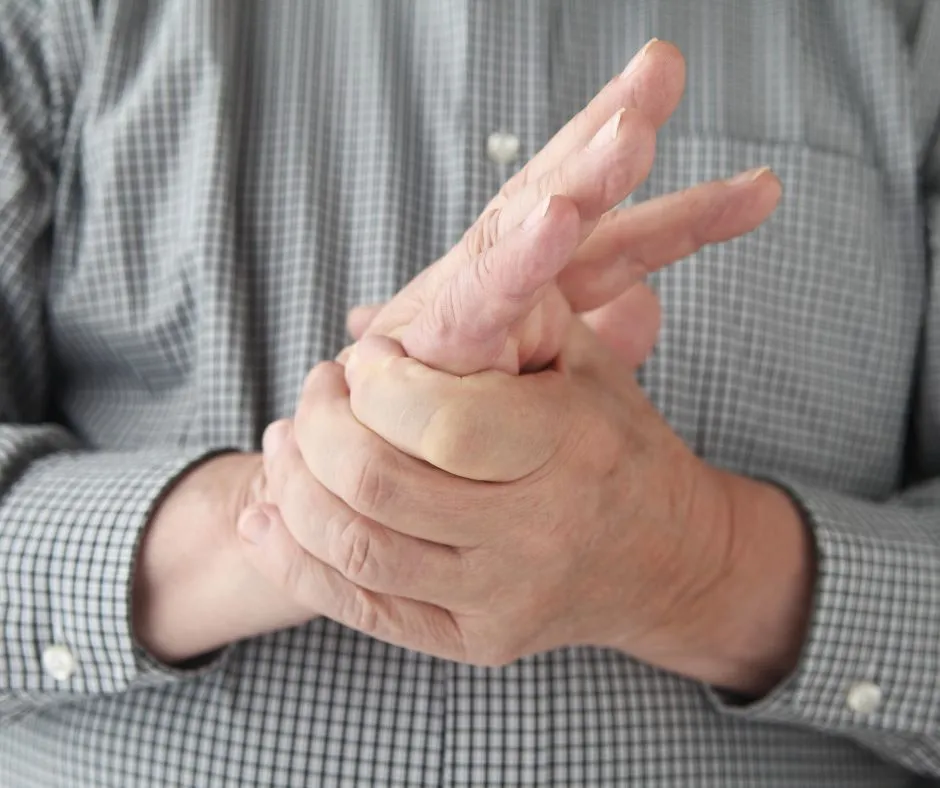 Person rubbing hands caused by tingling created by magnesium deficiency